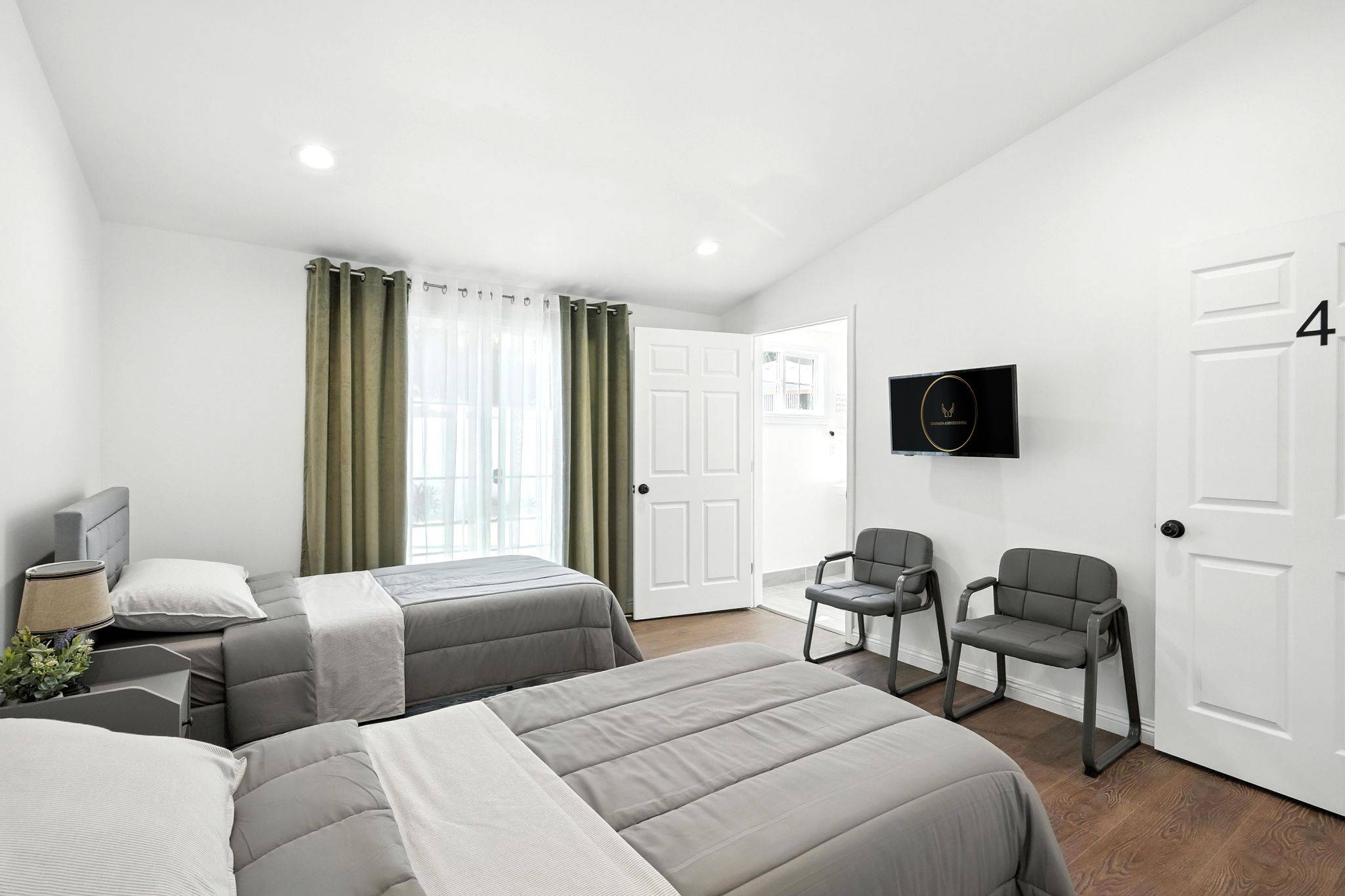 Comfortable and spacious shared bedroom at Granada Assisted Living featuring two neatly arranged beds, soft décor, and ample natural light
